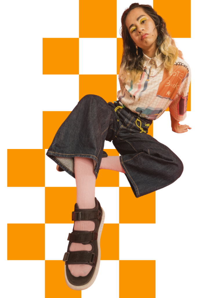 Orange checkered background with girl posing